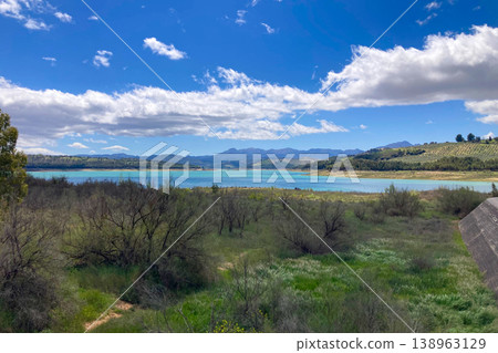 Los Bermejales Reservoir is a tranquil body of water surrounded by scenic natural landscapes and pine forests in the province of Granada, Spain 138963129