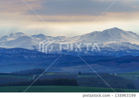 A view of the hills and the Daisetsuzan Mountains from Miyama Pass in Kamifurano, Hokkaido. A view of the hills and the Daisetsuzan Mountains from Miyama Pass in Kamifurano, Hokkaido. 138963199