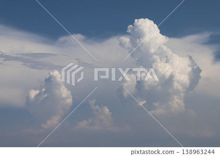 Summer cumulonimbus clouds - three cumulonimbus clouds lined up. Summer cumulonimbus clouds - three cumulonimbus clouds lined up. 138963244