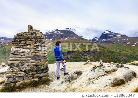 Tourist with camera in Norway mountains Tourist with camera in Norway mountains 138963347