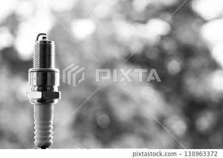 Auto service. New spark plug as spare part of car. 138963372