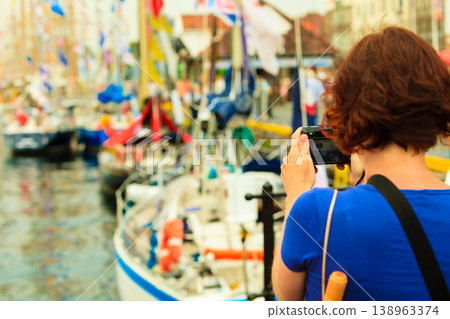 Tourism. Woman with camera on harbour, Bergen in Norway. 138963374