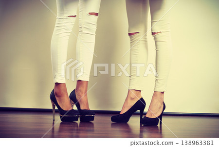 Two women legs presenting high heels Two women legs presenting high heels 138963381