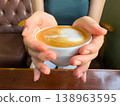 Hand coffee latte foam cup female cozy hand coffee latte foam cup female cozy moment in cafe with hot drink on wooden table 138963595