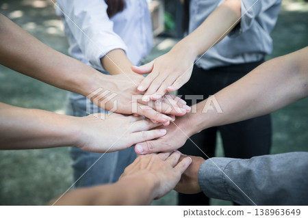 Top view of group of people team showing unity with putting their hands together in circle. Diversity hands join together for support and teamwork. Concept of teamwork. 138963649