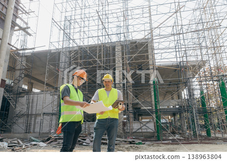 Confident team of architect working together in building construction site. They discussing about new startup project. Architect discuss with engineer about project . Architectural concept. 138963804