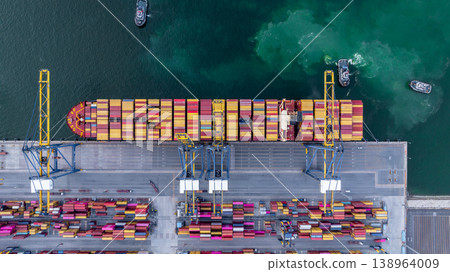 Aerial view container cargo ship at deep sea port terminal with tugboat assisting container cargo ship, Global trade and maritime supply chain, Logistics and transportation freight business industry. Aerial view container cargo ship at deep sea port terminal with tugboat assisting container cargo ship, Global trade and maritime supply chain, Logistics and transportation freight business industry. 138964009