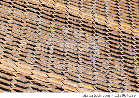 Close-up of a rusty metal mesh showing weathered texture Close-up of a rusty metal mesh showing weathered texture 138964159