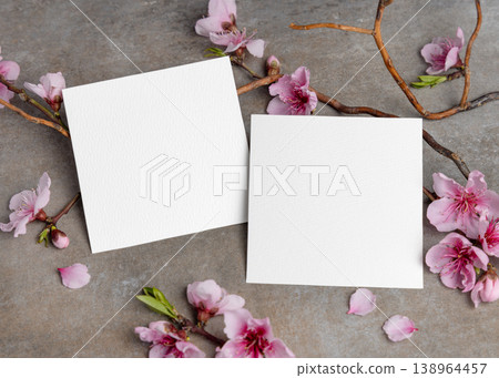 Blank cards mockup with pink cherry blossoms and twigs on grey stone. Spring wedding stationery set 138964457