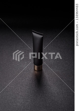 Black empty plastic tube for cream, paste, or shampoo as a mockup. An empty cosmetic tube mockup Black empty plastic tube for cream, paste, or shampoo as a mockup. An empty cosmetic tube mockup 138964483