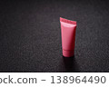 Pink empty plastic tube for cream, paste or shampoo as a mockup. Empty cosmetic tube mockup 138964490