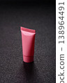 Pink empty plastic tube for cream, paste or shampoo as a mockup. Empty cosmetic tube mockup 138964491
