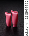 Pink empty plastic tube for cream, paste or shampoo as a mockup. Empty cosmetic tube mockup 138964492