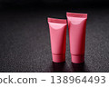 Pink empty plastic tube for cream, paste or shampoo as a mockup. Empty cosmetic tube mockup 138964493