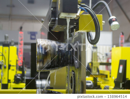 Wire-cut electrical discharge machine. Operation of wire-EDM machine cutting metal parts. Electrical discharge machine EDM cutting metal workpiece. Cutting process by wire cut machine. Metalworking Wire-cut electrical discharge machine. Operation of wire-EDM machine cutting metal parts. Electrical discharge machine EDM cutting metal workpiece. Cutting process by wire cut machine. Metalworking 138964514