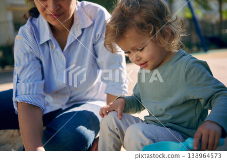 Mother And Toddler Playing Together In Park Sandbox Sharing A Tender Outdoor Moment Mother And Toddler Playing Together In Park Sandbox Sharing A Tender Outdoor Moment 138964573