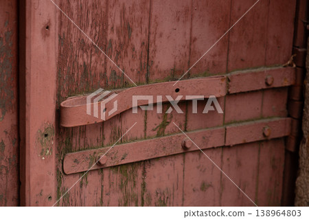 Rustic Red Wooden Gate with Weathered Paint and Vintage Metal Hinges Rustic Red Wooden Gate with Weathered Paint and Vintage Metal Hinges 138964803