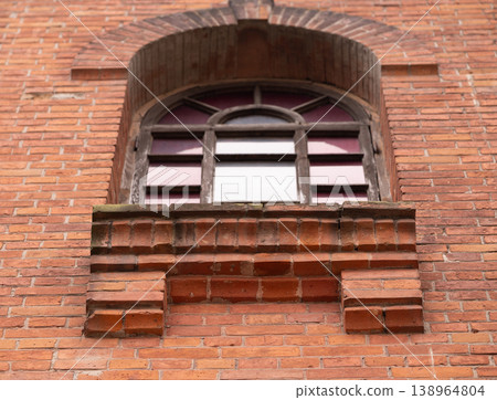 Old Red Brick Building Exterior with Arched Window and Decorative Ledge Old Red Brick Building Exterior with Arched Window and Decorative Ledge 138964804