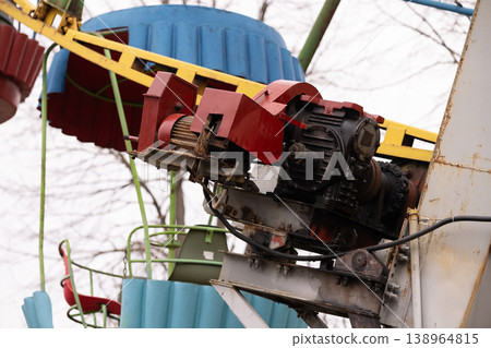 Close Up of Industrial Electric Motor and Gearbox Mechanism on Amusement Park Ride Structure 138964815