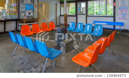 Muroran, Hokkaido, Japan - Oct 04 2024, close-up view of the waiting room with chairs placed around the potbelly stove, at one of the stations in Muroran, Japan Muroran, Hokkaido, Japan - Oct 04 2024, close-up view of the waiting room with chairs placed around the potbelly stove, at one of the stations in Muroran, Japan 138964873