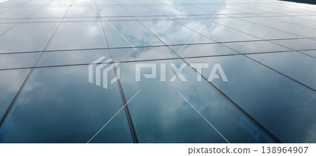 Sky mirror on a glass wall Sky mirror on a glass wall 138964907