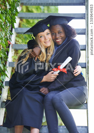 Graduation, college and women or friends hug for education achievement, success and celebration of diploma. Portrait of students in diversity with law certificate, university campus by stairs Graduation, college and women or friends hug for education achievement, success and celebration of diploma. Portrait of students in diversity with law certificate, university campus by stairs 138964983