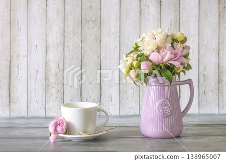 Happy birthday or mothers day still life; bouquet of pink and white peony flowers, white cup of tea on a marble background; Happy birthday or mothers day still life; bouquet of pink and white peony flowers, white cup of tea on a marble background; 138965007
