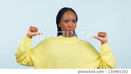 Portrait, attitude and a pointing black woman with confidence in studio on a gray background. Face, frown and expression with a young person looking serious about her fashion or style choice 138965102