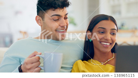 Couple, laptop and coffee on couch, laugh or reading for funny story, notification or post on web. Man, woman and computer for meme, streaming comic movie or happy on social network website in home 138965115