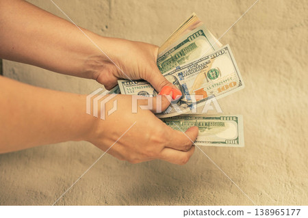 Money is in women's hands. The girl counts the money. 138965177