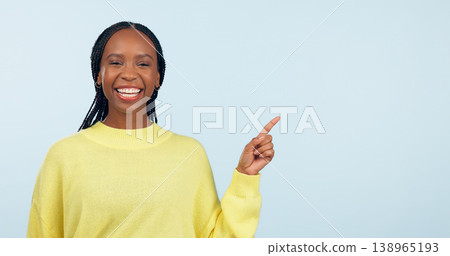 Pointing, smile and black woman with opportunity, portrait and announcement on a blue studio background. African person, model or girl with hand gesture, mockup space and choice with decision or news 138965193