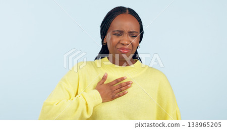 Woman, sick and pain of chest in studio for medical crisis, tuberculosis and cardiovascular healthcare on blue background. African model, heart attack and help for acid reflux, asthma and emergency Woman, sick and pain of chest in studio for medical crisis, tuberculosis and cardiovascular healthcare on blue background. African model, heart attack and help for acid reflux, asthma and emergency 138965205