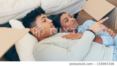 Couple, hug and pointing with boxes in new home after move with real estate, property investment or purchase agreement. Man, woman and married with security in vision for future, family and growth 138965306