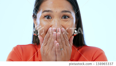 Portrait, wow and surprise with an asian woman in studio on a blue background to hear gossip or an announcement. Face, emoji and shock with a mind blown young person looking amazed by fake news Portrait, wow and surprise with an asian woman in studio on a blue background to hear gossip or an announcement. Face, emoji and shock with a mind blown young person looking amazed by fake news 138965337