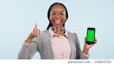 Business woman, thumbs up and green screen phone with portrait for review, choice or app by blue background. African entrepreneur, yes and studio for smartphone mockup, chromakey or tracking markers 138965393