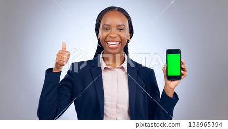 Green screen, phone and thumbs up by business woman in studio with mockup on grey background. Smartphone, app and portrait of African female entrepreneur with emoji, vote or support for app platform Green screen, phone and thumbs up by business woman in studio with mockup on grey background. Smartphone, app and portrait of African female entrepreneur with emoji, vote or support for app platform 138965394