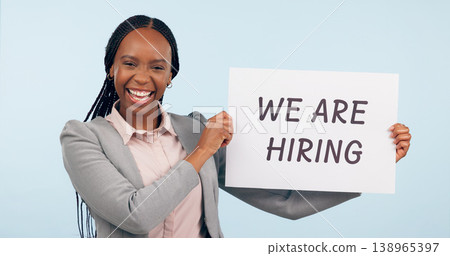 Business woman, hiring sign and studio portrait with smile for recruitment, welcome or search by blue background. African manager, human resources expert or poster for talent, employee or opportunity 138965397