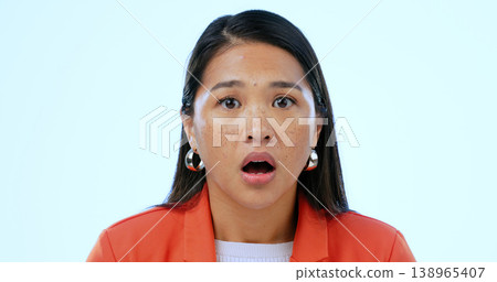 Woman, portrait and surprised or shocked in studio for announcement, scared and mouth open on blue background. Face, person and wow emoji or omg facial expression, mind blown and amazed at gossip 138965407