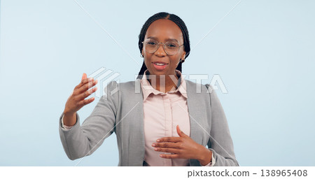 Black business woman, advice and studio portrait in suit, networking or presentation of info by blue background. Financial advisor, gesture or speech for investment, stock market knowledge or trading Black business woman, advice and studio portrait in suit, networking or presentation of info by blue background. Financial advisor, gesture or speech for investment, stock market knowledge or trading 138965408