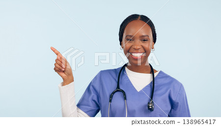 Portrait, information and a nurse black woman pointing to space in studio on a blue background for healthcare. Smile, medical and checklist with a happy young medicine professional showing mockup Portrait, information and a nurse black woman pointing to space in studio on a blue background for healthcare. Smile, medical and checklist with a happy young medicine professional showing mockup 138965417