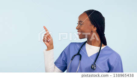 Smile, information and a nurse black woman pointing to space in studio on a blue background for healthcare. Medical, presentation and checklist with a happy young medicine professional showing mockup Smile, information and a nurse black woman pointing to space in studio on a blue background for healthcare. Medical, presentation and checklist with a happy young medicine professional showing mockup 138965438