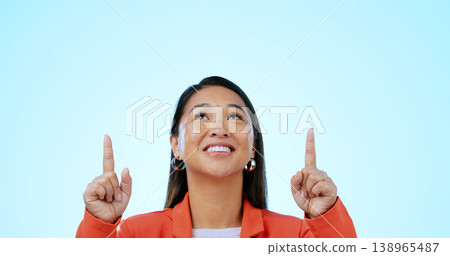Business woman, face and pointing up in studio for advertising choice, decision and information about us on blue background. Happy asian worker, thinking and presentation of mockup ads, ideas or deal 138965487
