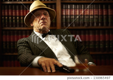 Man, mafia and boss or gun serious face for crime gangster, whiskey in office. Male person, hitman and portrait of killer for weapon pistol or danger violence for spy interrogation, business or power 138965497