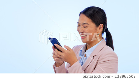 Business, woman and phone in studio for search, networking and planning with happy expression on blue background. Person, smartphone or technology for scrolling on social media or website on mock up 138965502