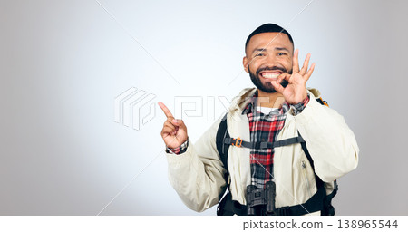 Hiking portrait, pointing and happy man okay sign for studio promotion, discount deal offer or travel vacation agreement. Ok emoji icon, mockup space and studio hiker backpacking on white background Hiking portrait, pointing and happy man okay sign for studio promotion, discount deal offer or travel vacation agreement. Ok emoji icon, mockup space and studio hiker backpacking on white background 138965544
