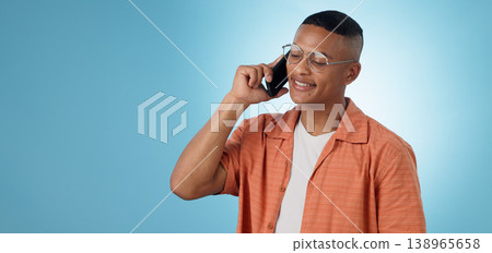 Phone call, mockup space or happy man in studio on blue background talking for communication. Modern, trendy or cool biracial model listening or calling to chat in conversation or speaking on mobile Phone call, mockup space or happy man in studio on blue background talking for communication. Modern, trendy or cool biracial model listening or calling to chat in conversation or speaking on mobile 138965658