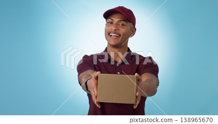 Portrait, happy man and courier with delivery in studio for mock up on blue background in Cape Town. Male model, smile and excited for logistics, shipping or distribution of package, parcel or order 138965670