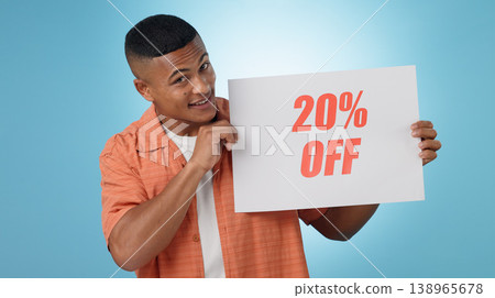 Portrait, man and poster for sale in studio with mock up for discount on blue background. Cape Town, male model and smile with announcement, promotion and sign on board with presentation in space 138965678
