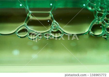 Cosmetic bubbles on green liquid surface creating abstract texture 138965772