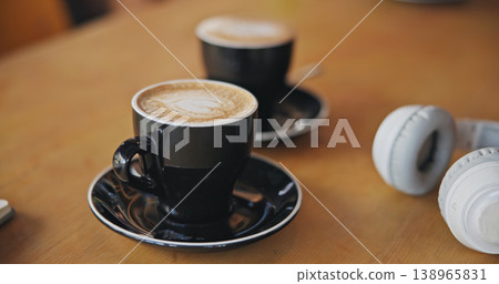 Coffee, cafe or headphones on table at breakfast for cappuccino, drink or matcha in diner. Background, restaurant or tea cup for latte, espresso or closeup with audio tech in morning in a shop Coffee, cafe or headphones on table at breakfast for cappuccino, drink or matcha in diner. Background, restaurant or tea cup for latte, espresso or closeup with audio tech in morning in a shop 138965831